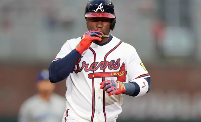 Atlanta Braves' Ozzie Albies (1) celebrates his solo homer against the Kansas City Royals during the first inning of an opening-day baseball game, Friday, March 27, 2026, in Atlanta. (AP Photo/Mike Stewart)