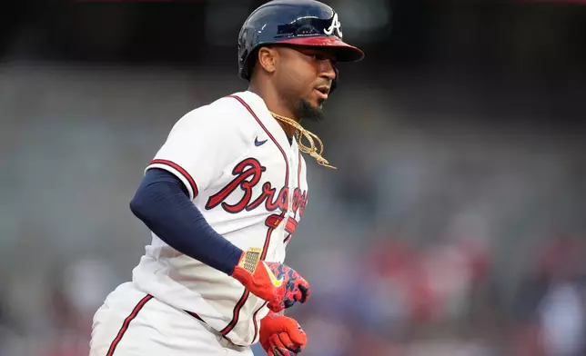 Atlanta Braves' Ozzie Albies (1) celebrates his solo homer against the Kansas City Royals during the first inning of an opening-day baseball game, Friday, March 27, 2026, in Atlanta. (AP Photo/Mike Stewart)