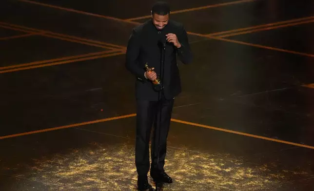 Michael B. Jordan accepts the award for actor in a leading role for "Sinners" during the Oscars on Sunday, March 15, 2026, at the Dolby Theatre in Los Angeles. (AP Photo/Chris Pizzello)