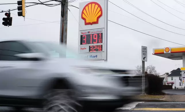 Fuel prices are displayed at a gas station as cars drive by, Wednesday, March 4, 2026, in Baltimore. (AP Photo/Stephanie Scarbrough)
