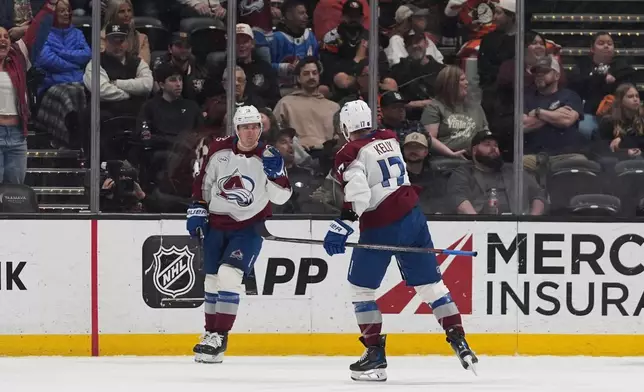 Colorado Avalanche center Parker Kelly (17) celebrates his goal with teammate right wing Valeri Nichushkin during the third period of an NHL hockey game against the Anaheim Ducks Tuesday, March 3, 2026, in Anaheim, Calif. (AP Photo/Gregory Bull)