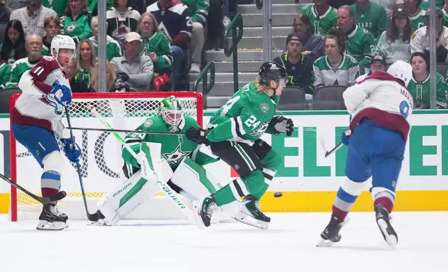 Colorado Avalanche defenseman Cale Makar, right, scores on a power play shot against Dallas Stars goaltender Jake Oettinger (29) during the first period of an NHL hockey game Friday, March 6, 2026, in Dallas. (AP Photo/Julio Cortez)