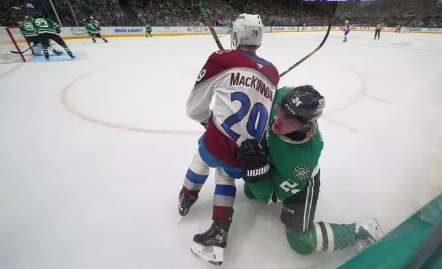 Colorado Avalanche center Nathan MacKinnon (29) and Dallas Stars center Roope Hintz (24) scuffle during the second period of an NHL hockey game Friday, March 6, 2026, in Dallas. (AP Photo/Julio Cortez)