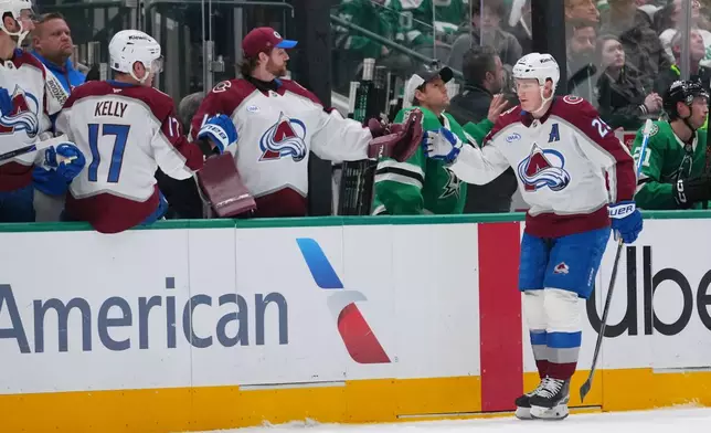 Colorado Avalanche center Nathan MacKinnon skates by his bench after scoring a goal against the Dallas Stars during the first period of an NHL hockey game Friday, March 6, 2026, in Dallas. (AP Photo/Julio Cortez)