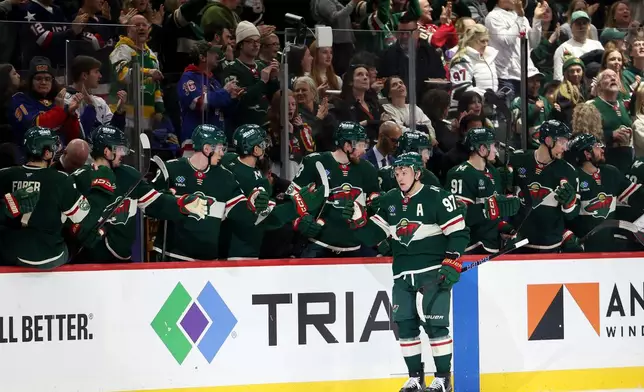 Minnesota Wild left wing Kirill Kaprizov (97) celebrates at the bench after scoring a goal during the second period of an NHL hockey game against the St. Louis Blues, Sunday, March 1, 2026, in St. Paul, Minn. (AP Photo/Ellen Schmidt)