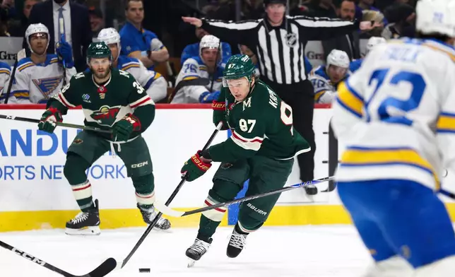 Minnesota Wild left wing Kirill Kaprizov (97) takes the puck upice against the St. Louis Blues during the first period of an NHL hockey game Sunday, March 1, 2026, in St. Paul, Minn. (AP Photo/Ellen Schmidt)