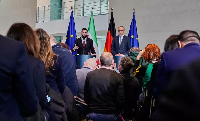 German Chancellor Friedrich Merz, right, and Syrian President Ahmad al-Sharaa attend a press conference in Berlin, Germany, Monday, March 30, 2026. (AP Photo/Markus Schreiber)