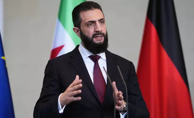 Syrian President Ahmad al-Sharaa attends a press conference after meeting with German Chancellor Friedrich Merz in Berlin, Germany, Monday, March 30, 2026. (AP Photo/Markus Schreiber)