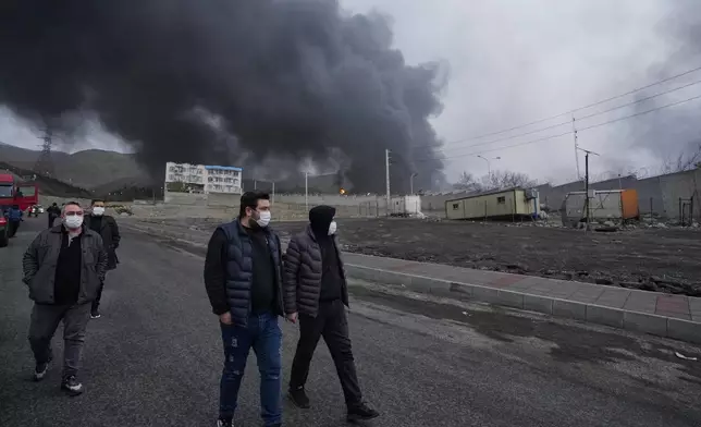 FILE - A thick plume of smoke rises Sunday, March 8, 2026, from an oil storage facility struck overnight in Tehran, Iran. (AP Photo/Vahid Salemi, File)