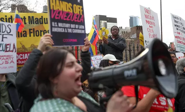 Demonstrators protest outside Manhattan federal court before a pre-trial hearing in former Venezuela President Nicolas Maduro's drug trafficking case, Thursday, March 26, 2026, in New York. (AP Photo/Heather Khalifa)