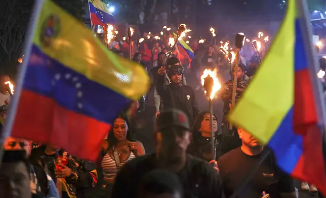 People march in support of former President Nicolas Maduro and first lady Cilia Flores in the 23 de Enero neighborhood in Caracas, Venezuela, Wednesday, March 25, 2026. (AP Photo/Pedro Mattey)