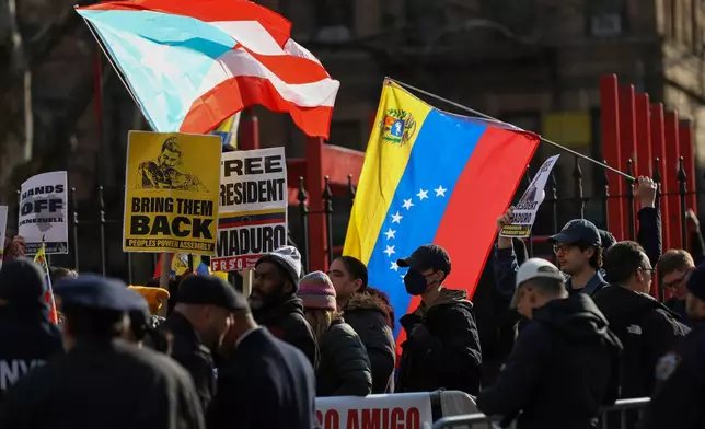 Demonstrators protest outside Manhattan federal court before a pre-trial hearing in former Venezuela President Nicolas Maduro's drug trafficking case, Thursday, March 26, 2026, in New York. (AP Photo/Heather Khalifa)
