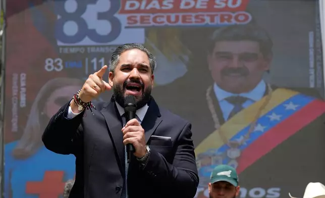 National Assembly lawmaker Nicolas Maduro Guerra, the son of former Venezuelan President Nicolas Maduro, speaks during a government-organized event to watch his father and his wife, Cilia Flores, appear in a New York court on a screen in Caracas, Venezuela, Thursday, March 26, 2026. (AP Photo/Ariana Cubillos)