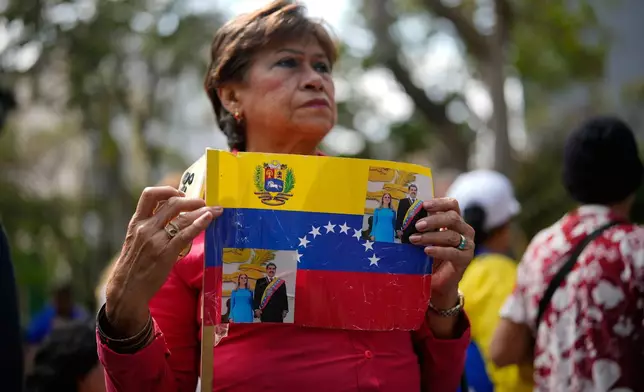 A woman attends a government-organized event to watch former President Nicolas Maduro and first lady Cilia Flores appear in a New York court on a screen in Caracas, Venezuela, Thursday, March 26, 2026. (AP Photo/Ariana Cubillos)