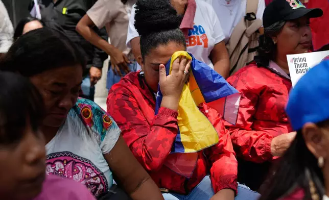 People react during a government-organized event to watch former President Nicolas Maduro and first lady Cilia Flores appear in a New York court on a screen in Caracas, Venezuela, Thursday, March 26, 2026. (AP Photo/Ariana Cubillos)