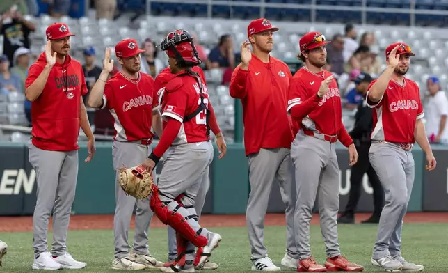 Canadian players celebrate at the end of a World Baseball Classic game Cuba in San Juan, Puerto Rico, Wednesday, March 11, 2026. (AP Photo/Alejandro Granadillo)
