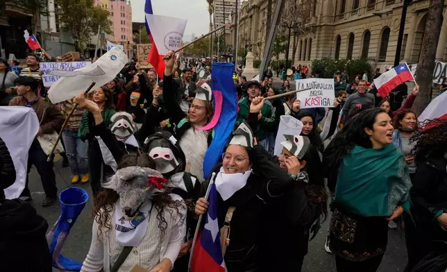 Protesters march during World Water Day demanding greater environmental protection and animal welfare, in Santiago, Chile, Sunday, March 22, 2026. (AP Photo/Esteban Felix)