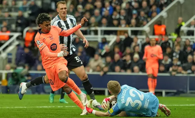 Newcastle's goalkeeper Aaron Ramsdale saves at the feet of Barcelona's Lamine Yamal during the Champions League round of 16 first leg soccer match between Newcastle United and Barcelona in Newcastle , England, Tuesday, March 10, 2026. (AP Photo/Jon Super)