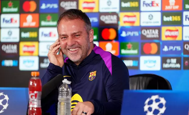 Barcelona manager Hansi Flick smiles during a press conference at St. James' Park, Newcastle upon Tyne, England, Monday March 9, 2026, ahead of the Champions League soccer match between Newcastle United and Barcelona on Tuesday. (Owen Humphreys/PA via AP)