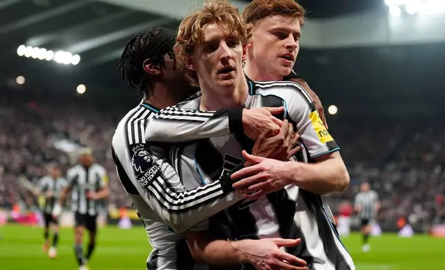 Newcastle United's Anthony Gordon, center, celebrates after scoring his sides first goal during their English Premier League soccer match against Manchester United in Newcastle, England, Wednesday, March 4, 2026. (Owen Humphreys/PA via AP)