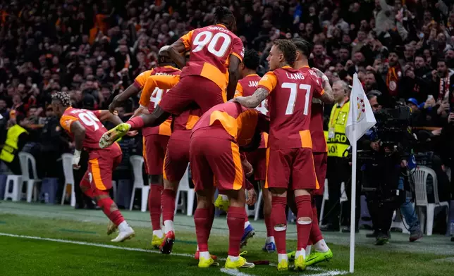 Galatasaray's players celebrate after teammate Mario Lemina scored the opening goal during a Champions League round of 16 first leg soccer match between Galatasaray and Liverpool, in Istanbul, Turkey, Tuesday, March 10, 2026. (AP Photo/Khalil Hamra)