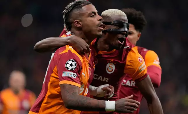 Galatasaray's Mario Lemina, left, celebrates after scoring the opening goal during a Champions League round of 16 first leg soccer match between Galatasaray and Liverpool, in Istanbul, Turkey, Tuesday, March 10, 2026. (AP Photo/Khalil Hamra)
