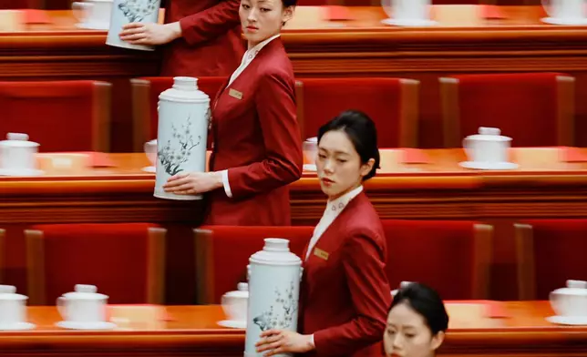 FILE - Hostesses prepare tea for delegates before the closing ceremony of the Chinese People's Political Consultative Conference (CPPCC) at the Great Hall of the People in Beijing, March 11, 2026. (AP Photo/Vincent Thian, File)