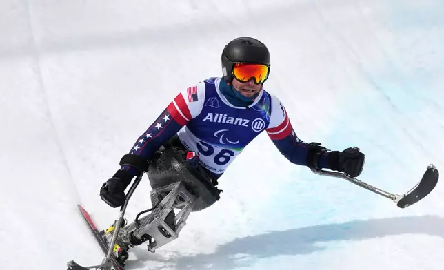 FILE- Ravi Drugan, of the United States, competes in the alpine skiing men's super-G sitting final at the 2026 Winter Paralympics, in Cortina d'Ampezzo, Italy, March 9, 2026. (AP Photo/Evgeniy Maloletka, File)