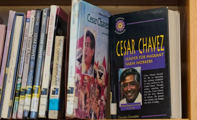 Books about Cesar Chavez are seen on a library shelf at San Lorenzo High School Wednesday, March 18, 2026, in San Lorenzo, Calif. (AP Photo/Godofredo A. Vásquez)