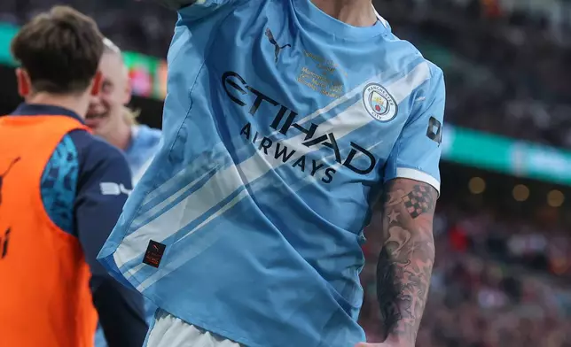 Manchester City's Nico O'Reilly celebrates after scoring the opening goal during the English League Cup final soccer match between Arsenal and Manchester City in London, Sunday, March 22, 2026. (AP Photo/Richard Pelham)