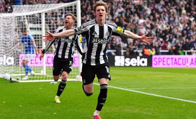 Newcastle United's Anthony Gordon celebrates scoring their side's first goal of the game during the Premier League match between Newcastle and Sunderland outside St James' Park, Newcastle upon Tyne, England, Sunday March 22, 2026. (Owen Humphreys/PA via AP)