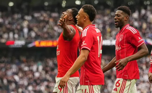 Nottingham Forest's Taiwo Awoniyi, left, celebrates with teammates after scoring his side's third goal during the English Premier League soccer match between Tottenham Hotspur and Nottingham Forest in London, Sunday, March 22, 2026. (AP Photo/Dave Shopland)