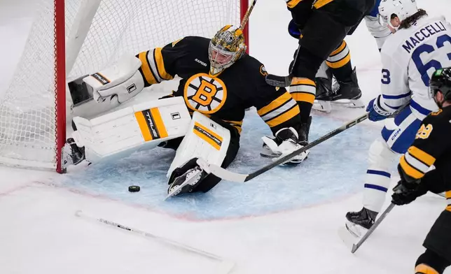 Boston Bruins goaltender Jeremy Swayman (1) drops to the ice to make a save, after losing his stick, on a shot by Toronto Maple Leafs left wing Matias MacCelli (63) during the first period of an NHL hockey game, Tuesday, March 24, 2026, in Boston. (AP Photo/Charles Krupa)