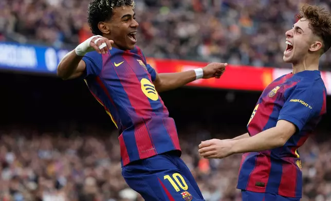 Barcelona's Lamine Yamal, left, celebrates scoring his side's opening goal with teammate Fermin Lopez during the Spanish La Liga soccer match between Barcelona and Villareal in Barcelona, Spain, Saturday, Feb. 28, 2026. (AP Photo/Joan Monfort)