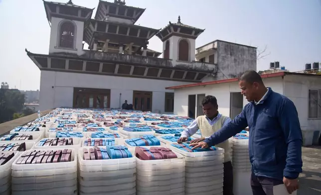 FILE - Election Commission staff inspect ballot boxes before loading onto a vehicle for delivery to various regions across the country ahead of the March 5 general election in Kathmandu, Nepal, on Feb. 8, 2026. (AP Photo/Niranjan Shrestha, File)