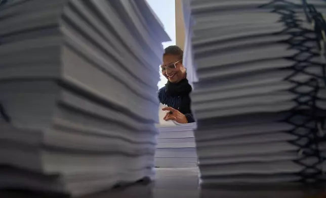 FILE - A staff member checks a voter list before distribution to various regions across the country for the upcoming general election scheduled for March 5, at the Election Commission in Kathmandu, Nepal, on Jan. 30, 2026. (AP Photo/Niranjan Shrestha, File)