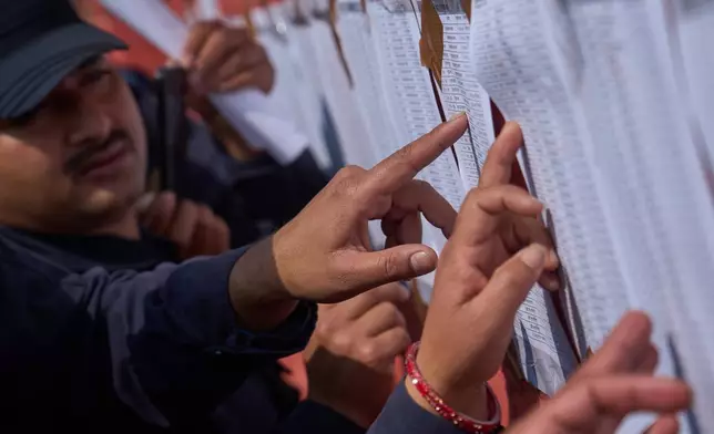 Nepalese police officers check a list showing their postings as they prepare to depart for duty in various regions ahead of the upcoming election in Kathmandu, Nepal, Feb. 23, 2026. (AP Photo/Niranjan Shrestha, file)