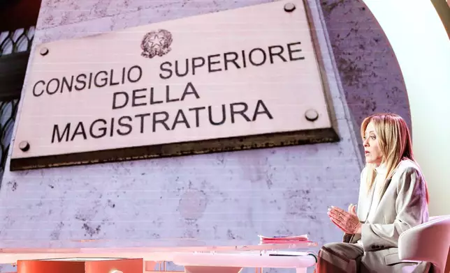 Italian premier Giorgia Meloni speaks about the upcoming referendum on a judicial reform during the RAI state television program Cinque minuti (Five Minutes), in Rome, Friday, March 20, 2026. Writing on placard on screen reads in Italian "Superior Council of Magistracy" (Roberto Monaldo /LaPresse via AP)