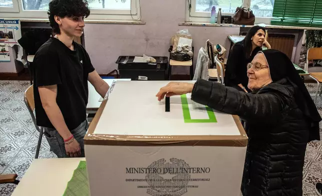 A nun votes in a referendum on judicial reform, at a polling station in Turin, Italy, Sunday March 22, 2026. (Daniele Solavaggione/LaPresse via AP)