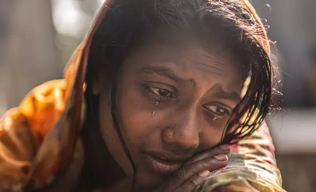 FILE - Meghna Rani, wife of Dipu Chandra Das who was beaten to death by a mob, his body hung from a tree and set on fire, for alleging making derogatory remarks about the Prophet Muhammad, weeps inside her home in Tarakanda, Bangladesh, Jan. 9, 2026. (AP Photo/Mahmud Hossain Opu, File)