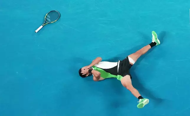 FILE - Carlos Alcaraz of Spain reacts after winning the men's singles final match against Novak Djokovic of Serbia at the Australian Open tennis championship in Melbourne, Australia, Feb. 1, 2026. (AP Photo/Dar Yasin, File)