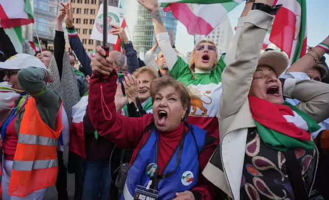 FILE - Iranians show their support for the U.S. and Israeli strikes on Iran, in Berlin, Germany, Feb. 28, 2026. (AP Photo/Markus Schreiber, File)