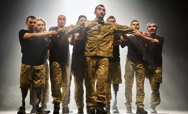 FILE - Ukrainian war veterans, many of whom sustained severe injuries in combat during Russia's full-scale invasion of Ukraine, perform during a theater premiere in in Kyiv, Feb. 19, 2026. (AP Photo/Efrem Lukatsky, File)