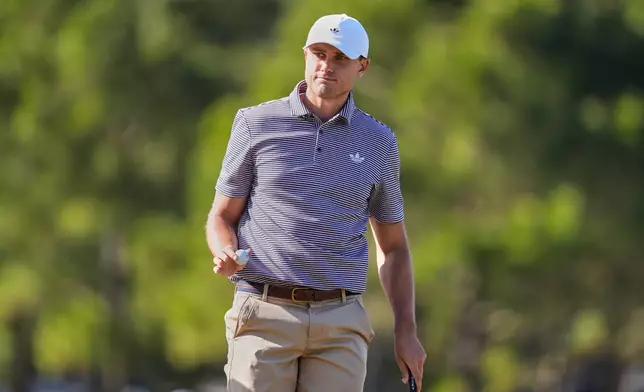 Ludvig Aberg of Sweden acknowledges applause from the gallery after sinking his putt on the 11th green during the second round of The Players Championship golf tournament Friday, March 13, 2026, in Ponte Vedra Beach, Fla. (AP Photo/Gerald Herbert)