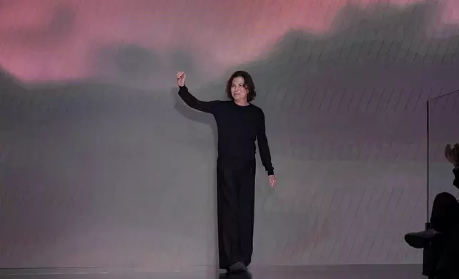 Silvana Armani is greeted by the public at the end of the Giorgio Armani Fall/Winter 2026-2027 Women's collection presented in Milan, Italy, Sunday, March 1, 2026. (AP Photo/Antonio Calanni)