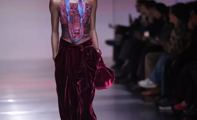 A model wears a creation from the Giorgio Armani Fall/Winter 2026-2027 Women's collection presented in Milan, Italy, Sunday, March 1, 2026. (AP Photo/Antonio Calanni)