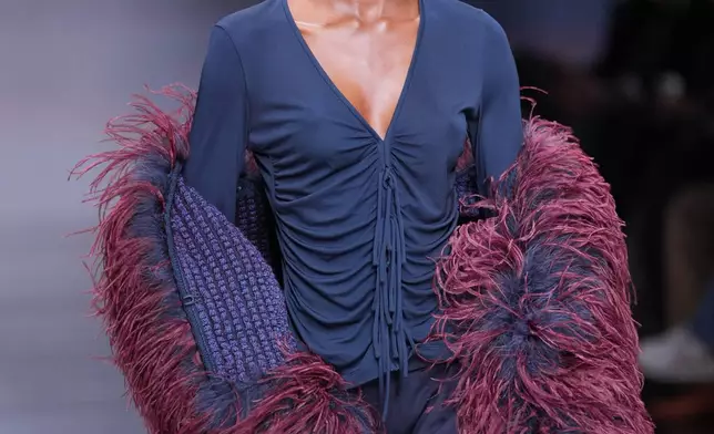 A model wears a creation from the Giorgio Armani Fall/Winter 2026-2027 Women's collection presented in Milan, Italy, Sunday, March 1, 2026. (AP Photo/Antonio Calanni)