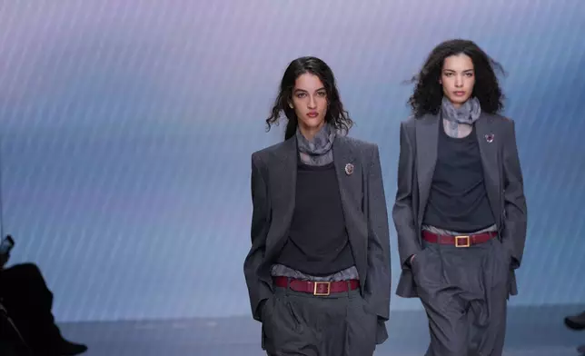 Models wear creations from the Giorgio Armani Fall/Winter 2026-2027 Women's collection presented in Milan, Italy, Sunday, March 1, 2026. (AP Photo/Antonio Calanni)