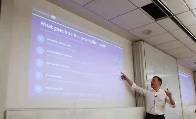 Professor Panos Ipeirotis speaks to students about an AI oral agent they'll be using for their final exam at NYU Stern School of Business, March 4, 2026, in New York. (AP Photo/Heather Khalifa)
