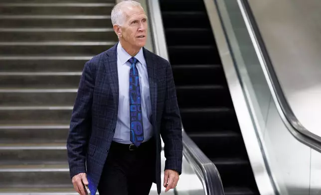Sen. Thom Tillis, R-N.C., descends an stairwell after a vote at the Capitol, Friday, March 20, 2026, in Washington. (AP Photo/Tom Brenner)